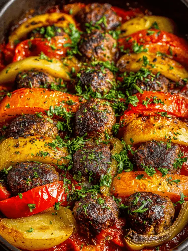 Baked beef meatballs with potatoes and mushrooms in tomato sauce